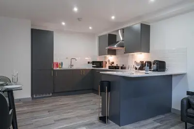 a kitchen with gray cabinets and a counter top at Lovely 1 Bedroom Apartment in Preston in Preston