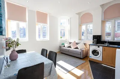 a living room with a table and a couch at Central Liverpool L1 in Liverpool