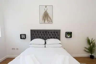 a bedroom with a white bed with white pillows at Central Liverpool L1 in Liverpool