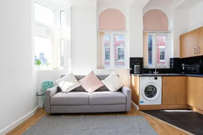 a living room with a couch and a washing machine at Central Liverpool L1 in Liverpool