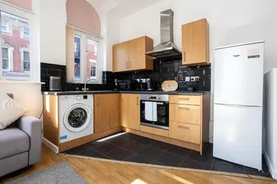 a kitchen with a refrigerator and a washing machine at Central Liverpool L1 in Liverpool