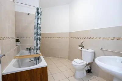 a bathroom with a toilet and a tub and a sink at Central Liverpool L1 in Liverpool