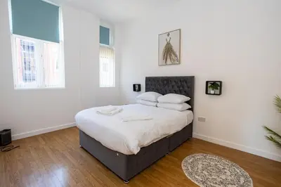 a bedroom with a large bed with white sheets and pillows at Central Liverpool L1 in Liverpool