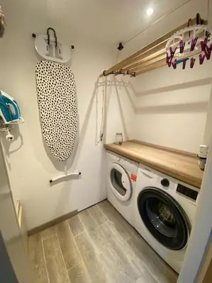 a laundry room with a washing machine and a sink at The Coach House in Blackpool