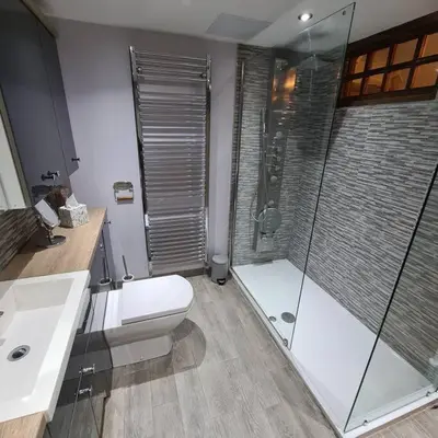a bathroom with a shower and a toilet and a sink at The Coach House in Blackpool