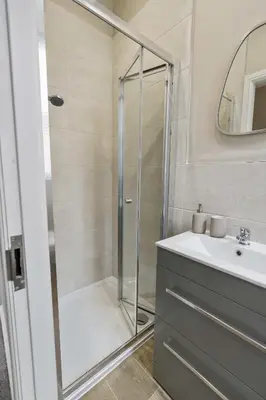 a bathroom with a shower and a sink at The Park Road Suites by Central Beach Leisure in Blackpool