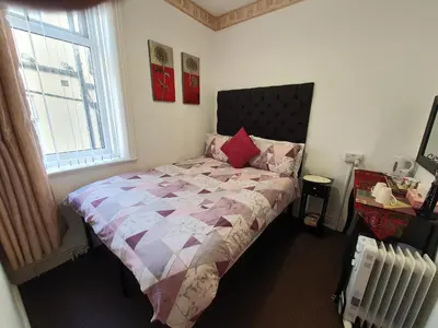 a bedroom with a bed and a window at Windsor House Hotel in Blackpool