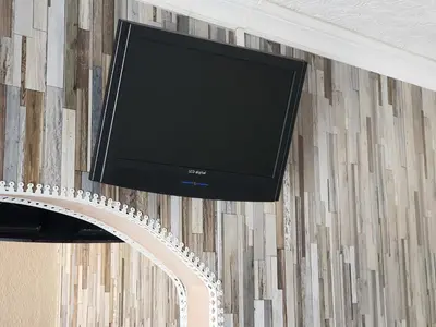 a flat screen tv hanging on a wall at Windsor House Hotel in Blackpool