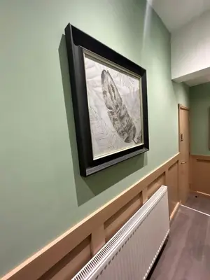 a picture of a butterfly on a wall with a radiator at Strawberry Fields Suite by Sasco Apartments in Blackpool