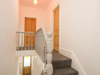 a staircase in a home with a white stair case at Anandom in Blackpool