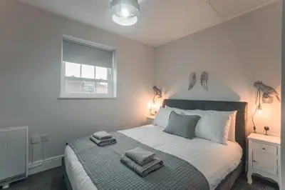 a bedroom with a bed with two towels on it at Clarence Street Town House in Liverpool