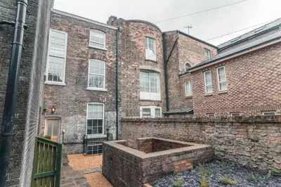 a brick building with a large brick wall at Clarence Street Town House in Liverpool