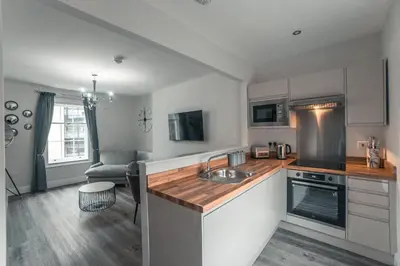 a kitchen with a sink and a counter top at Clarence Street Town House in Liverpool