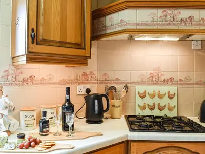 a kitchen with a stove and a counter top at Priory Barn in Burscough