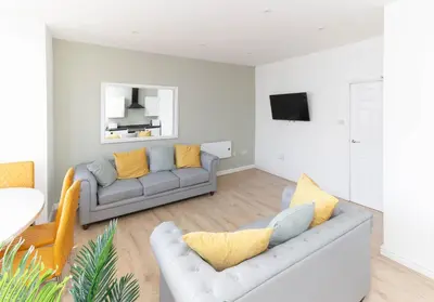 a living room with two couches and a tv at No 10 Apartments in Blackpool