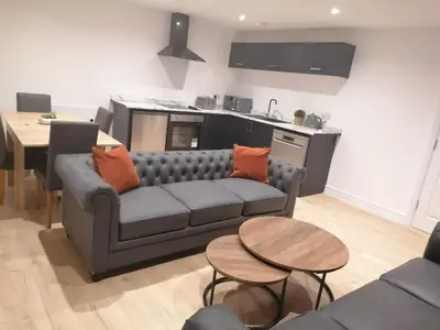 a living room with a couch and a kitchen at No 10 Apartments in Blackpool