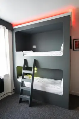 a bunk bed with a ladder in a room at The Breckfield Hotel in Liverpool