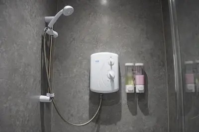 a shower in a bathroom with a blow dryer at The Breckfield Hotel in Liverpool