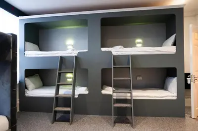 a room with three bunk beds in it at The Breckfield Hotel in Liverpool