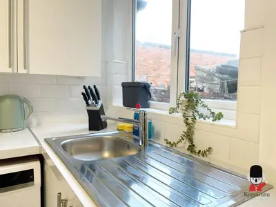 a kitchen with a sink and a window at KozyGuru / Wigan / 2BR 4Beds / Newly Refurbished Stylish Holiday House / Close to Big Retail Park / UWNE034 in Wigan