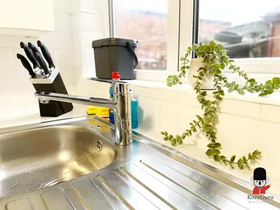 a kitchen sink with a plant next to a window at KozyGuru / Wigan / 2BR 4Beds / Newly Refurbished Stylish Holiday House / Close to Big Retail Park / UWNE034 in Wigan