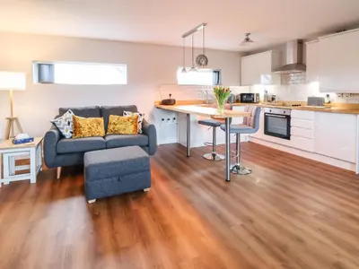 a living room with a couch and a table at Meols Holiday Lodge in Wirral