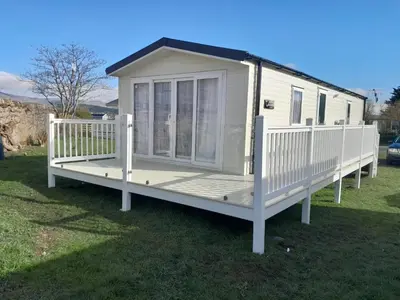 a mobile home with a porch on the grass at Beauview Brand New For 2023 Wi-Fi and Smart TV in Millom
