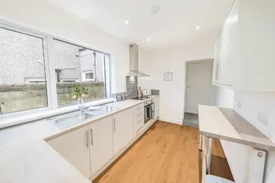 a white kitchen with a sink and a window at 24 Baden Powell in Barrow in Furness