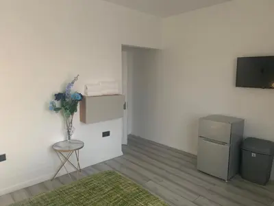 a room with a vase of flowers on a table at Bloomsbury House - Modern studios near Anfield in Liverpool