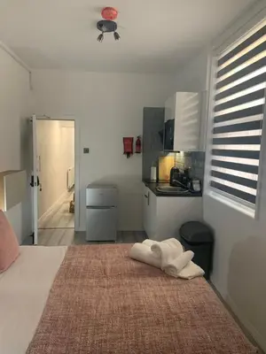 a bedroom with a bed with white towels on it at Bloomsbury House - Modern studios near Anfield in Liverpool