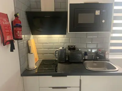 a kitchen counter with a sink and a microwave at Bloomsbury House - Modern studios near Anfield in Liverpool
