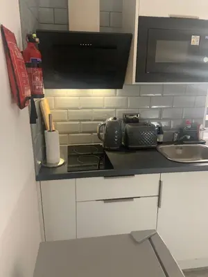 a kitchen counter with a stove and a sink at Bloomsbury House - Modern studios near Anfield in Liverpool