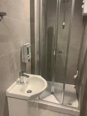 a bathroom with a shower and a toilet and a sink at Bloomsbury House - Modern studios near Anfield in Liverpool