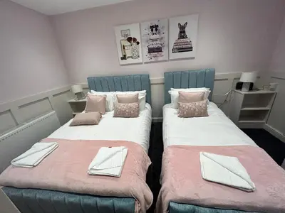 two beds sitting next to each other in a room at Sugar Hill Suite by Sasco Apartments in Blackpool