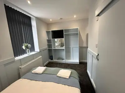 a small bedroom with a bed and a window at Sugar Hill Suite by Sasco Apartments in Blackpool