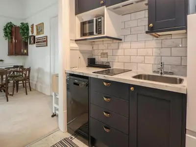 a kitchen with a sink and a counter top at Ismay Billiard Room Apartment - Titanic Interest in Crosby