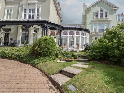 a large house with a brick walkway in front of it at Ismay Billiard Room Apartment - Titanic Interest in Crosby