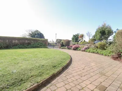 a brick walkway in a park with a green lawn at Ismay Billiard Room Apartment - Titanic Interest in Crosby