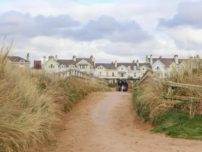 a dirt road in front of a row of houses at Ismay Billiard Room Apartment - Titanic Interest in Crosby