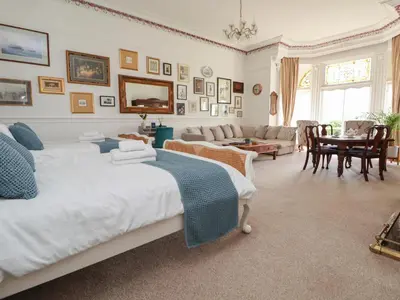 a bedroom with two beds and a living room at Ismay Dining Room Suite - Titanic Interest in Crosby