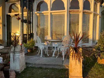a patio with a table and chairs on a house at Ismay Dining Room Suite - Titanic Interest in Crosby