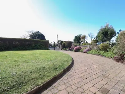 a brick walkway in a park with a green lawn at Ismay Dining Room Suite - Titanic Interest in Crosby