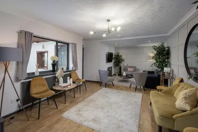 a living room with a couch and chairs at Bentinck Residence by Sasco Apartments, Lytham St Annes in Lytham St Annes