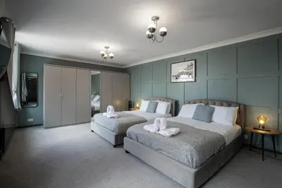 a bedroom with two beds with white towels on them at Bentinck Residence by Sasco Apartments, Lytham St Annes in Lytham St Annes
