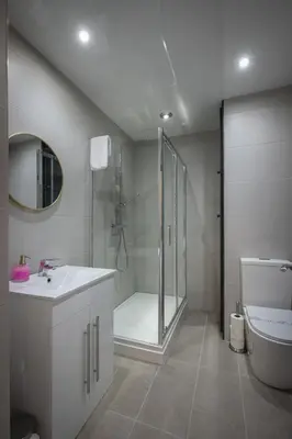 a bathroom with a shower and a sink and a toilet at Bentinck Residence by Sasco Apartments, Lytham St Annes in Lytham St Annes