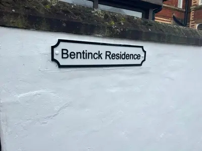 a sign on the side of a white wall at Bentinck Residence by Sasco Apartments, Lytham St Annes in Lytham St Annes