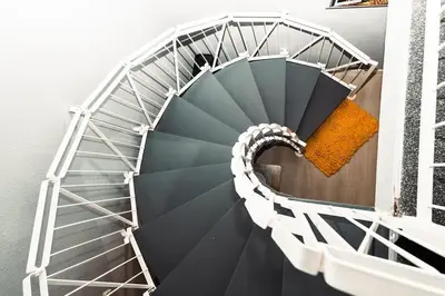 a spiral staircase with a yellow object on a building at Elegant 2 bed with hot tub and a host of amenities in Liverpool