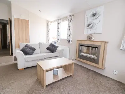 a living room with a couch and a fireplace at Rosella 38 in Morecambe