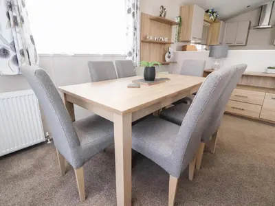 a dining room table with chairs around it at Rosella 38 in Morecambe