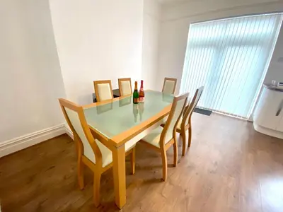 a dining room table and chairs in a room at Merseyside in Birkenhead